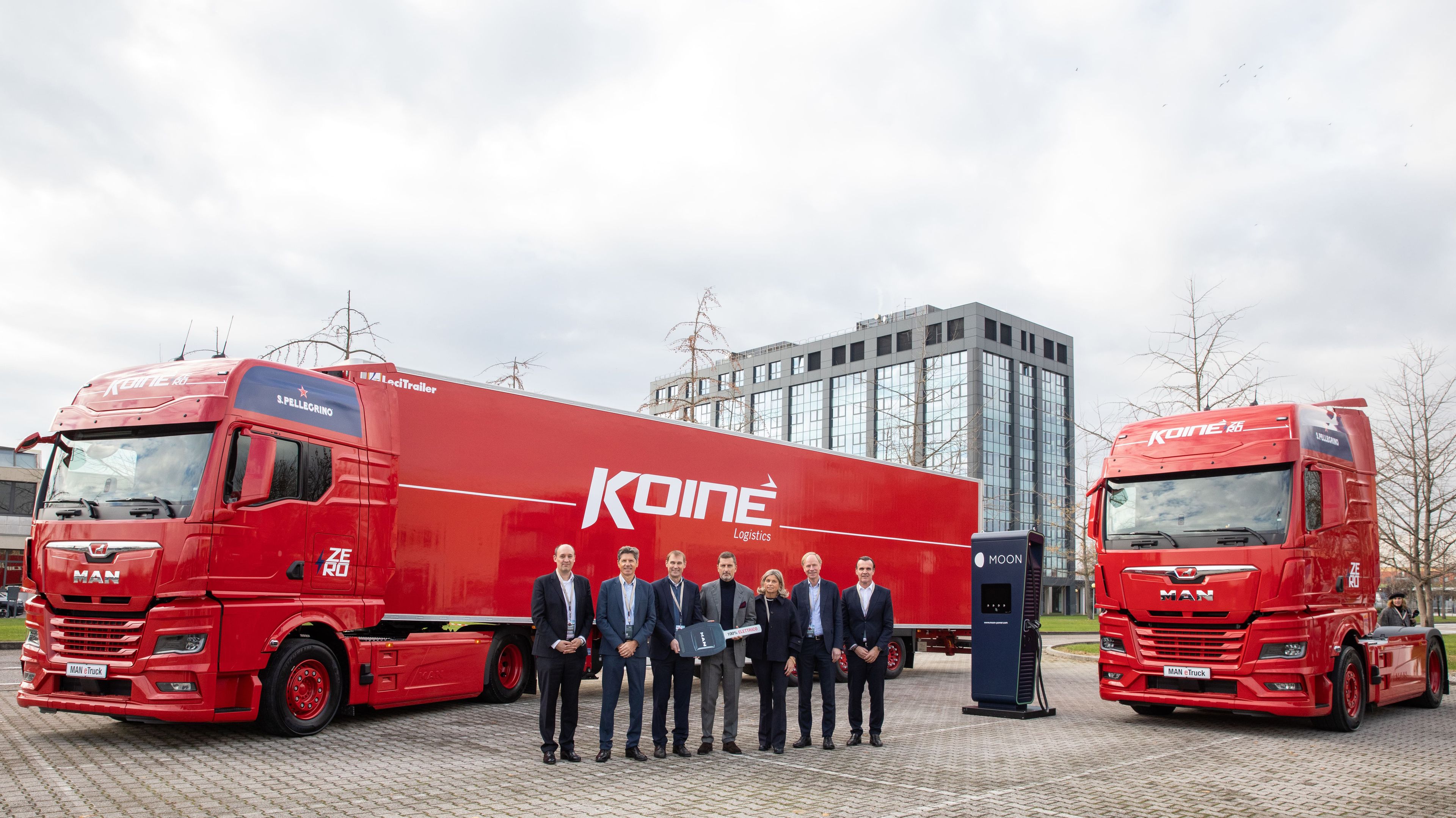 two Koiné trucks next to a POWER Charger HYC 400