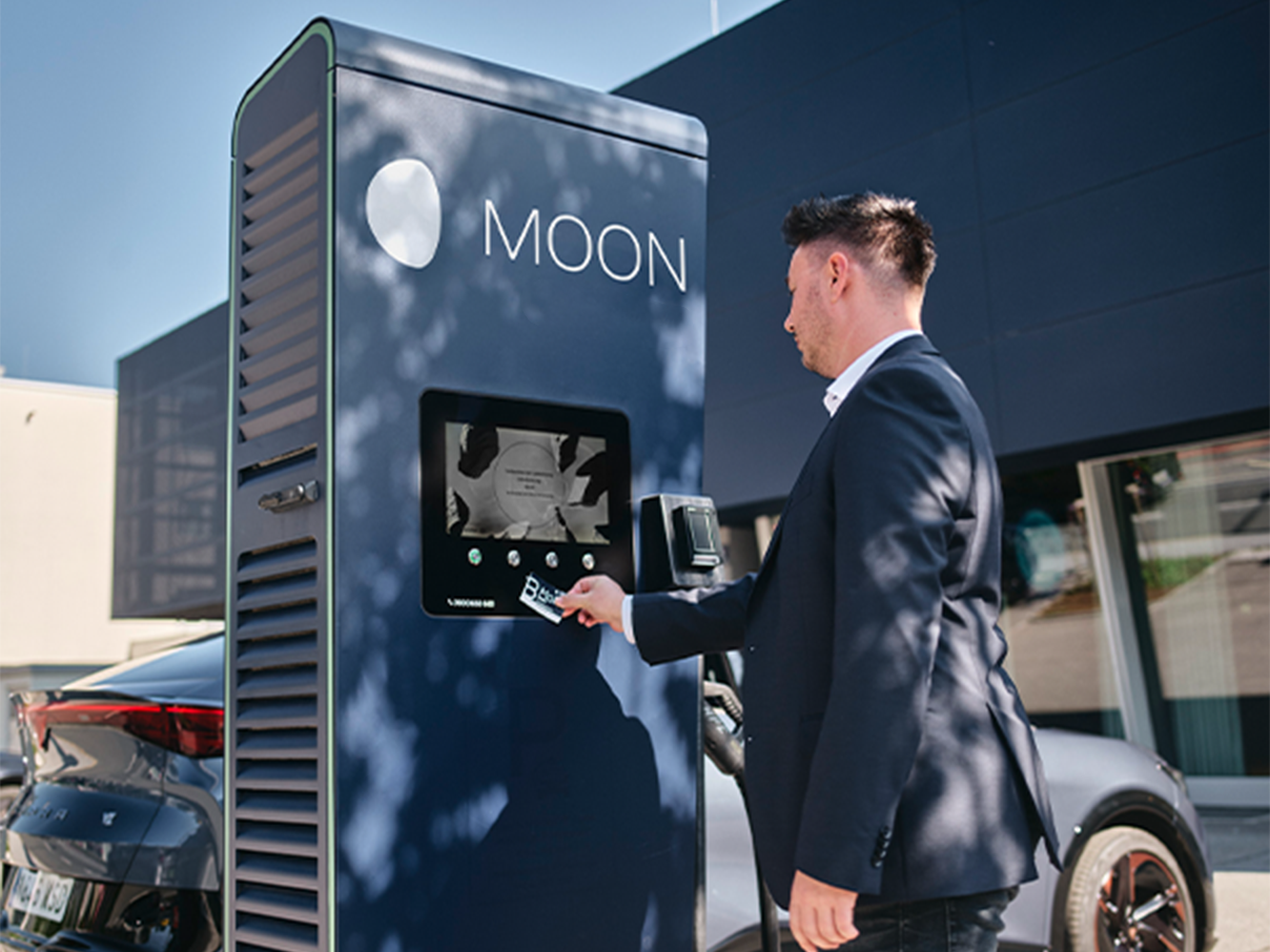 Card is held up to a display of a fast charging station