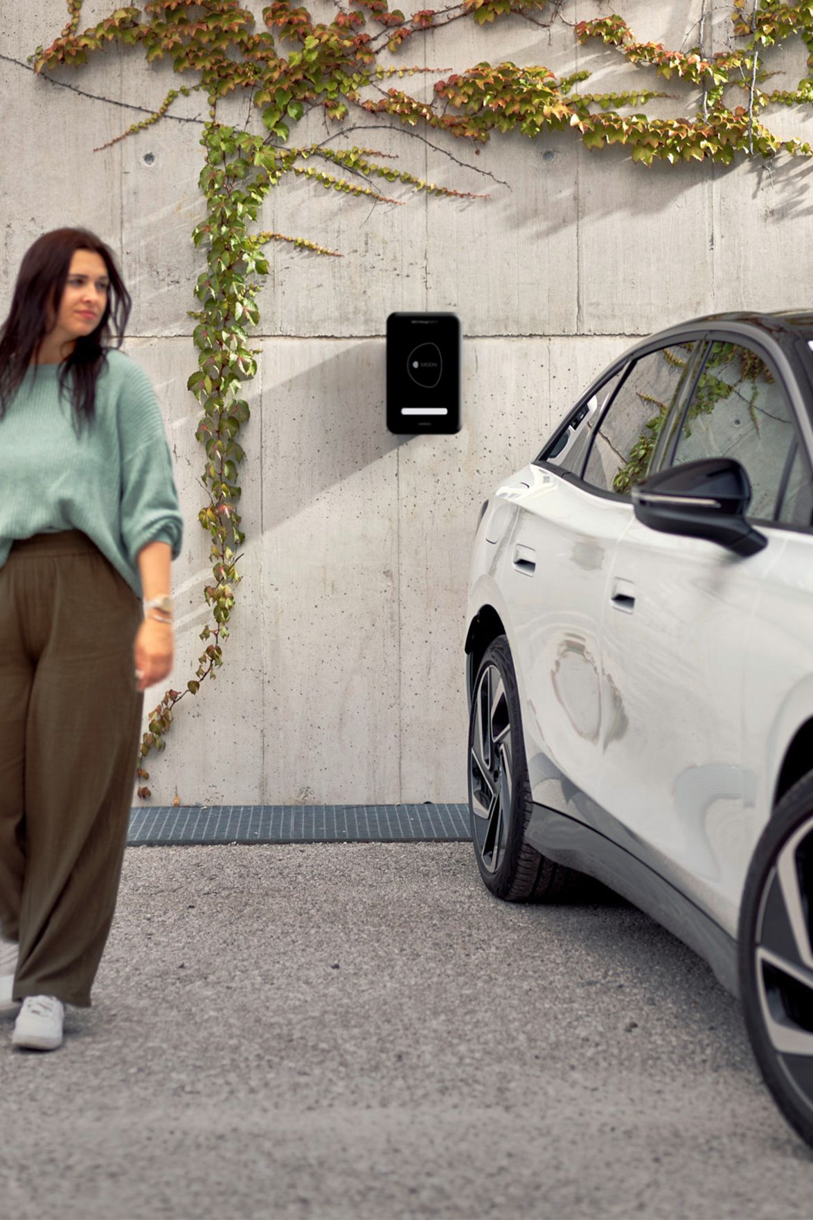 MOON POWER BiDi Charger on the wall behind a car