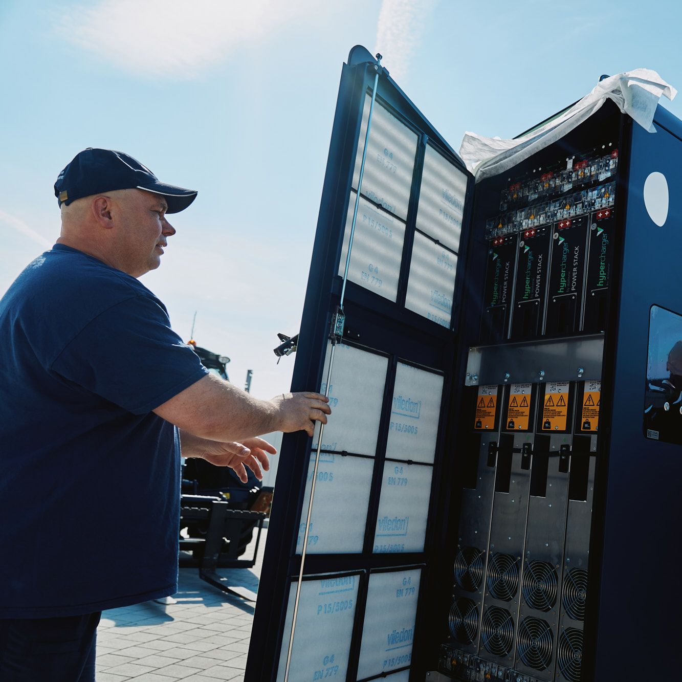 two men carry out the installation of a POWER Charger fast charging station