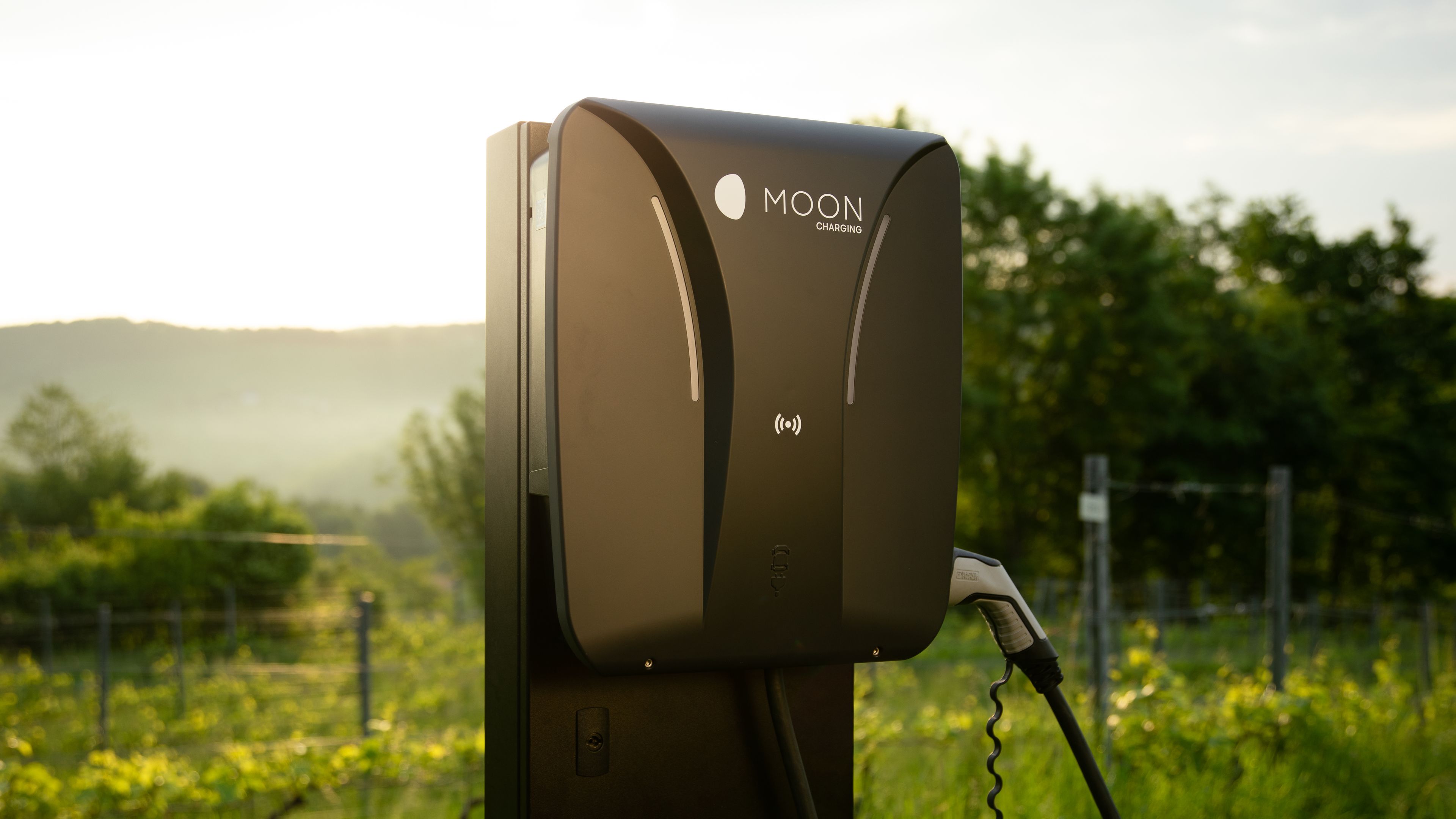 Close-up of a charging station at sunset