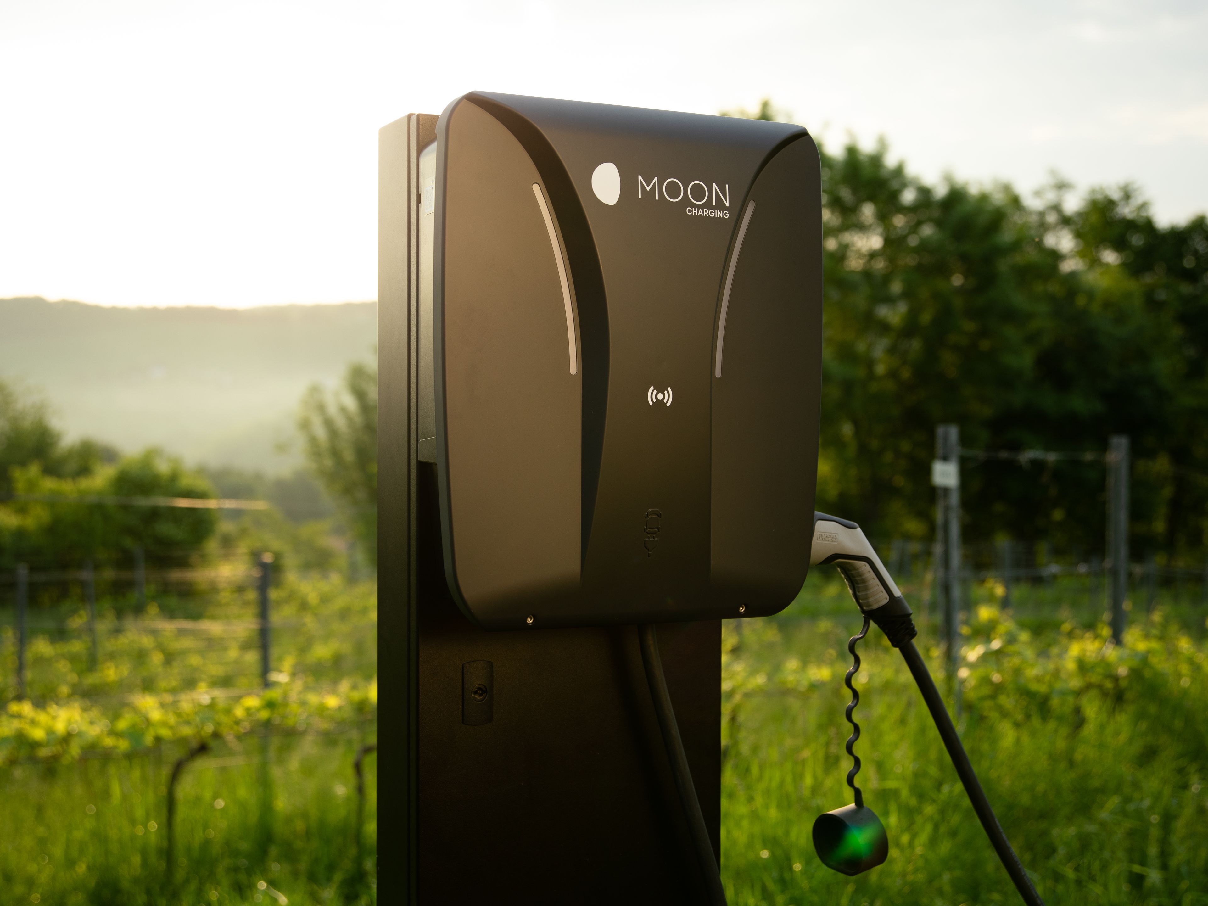 Close-up of a charging station at sunset