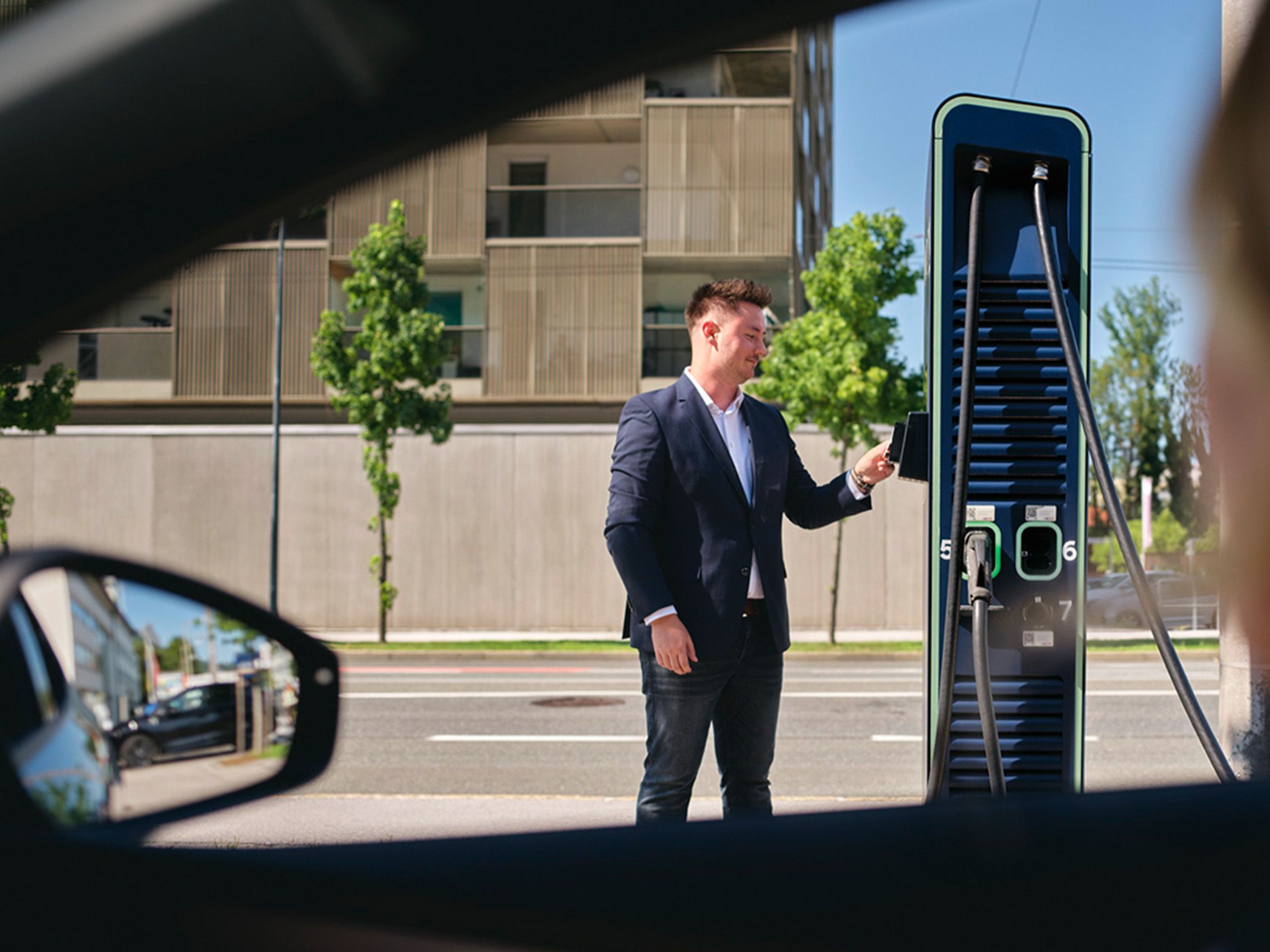 Person holds card to a charging station