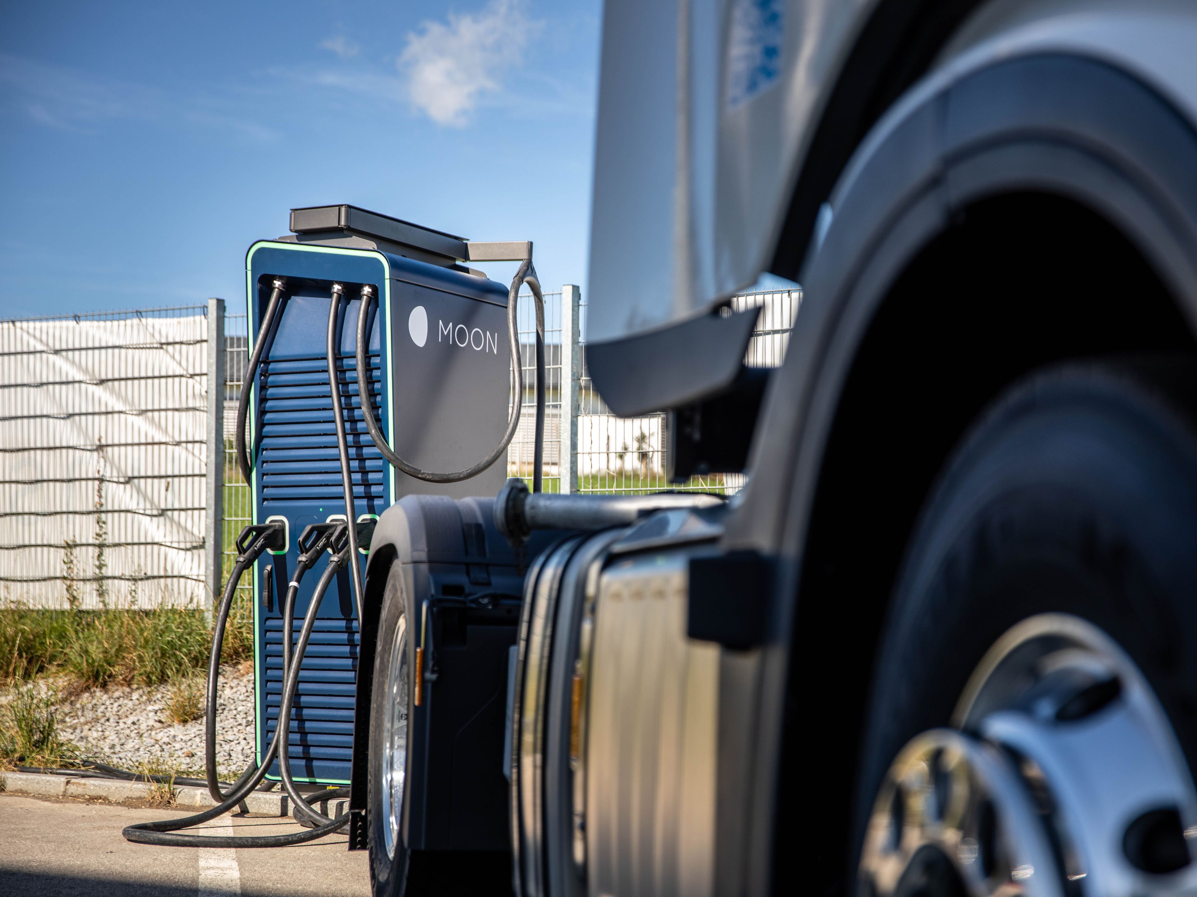 a truck stands in front of a HYC 200-400 fast charging station