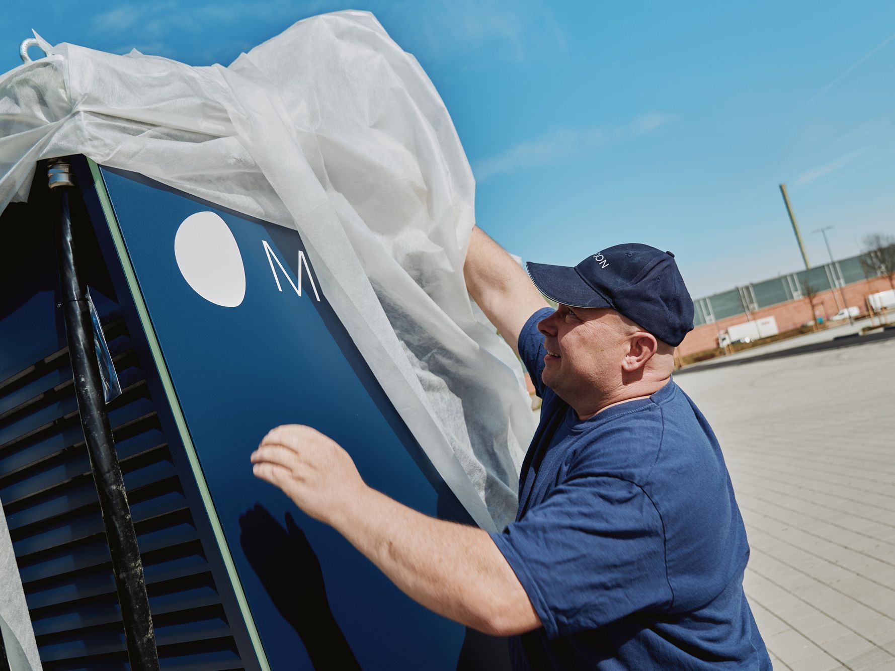 A man unpacks a POWER Charger fast charging station