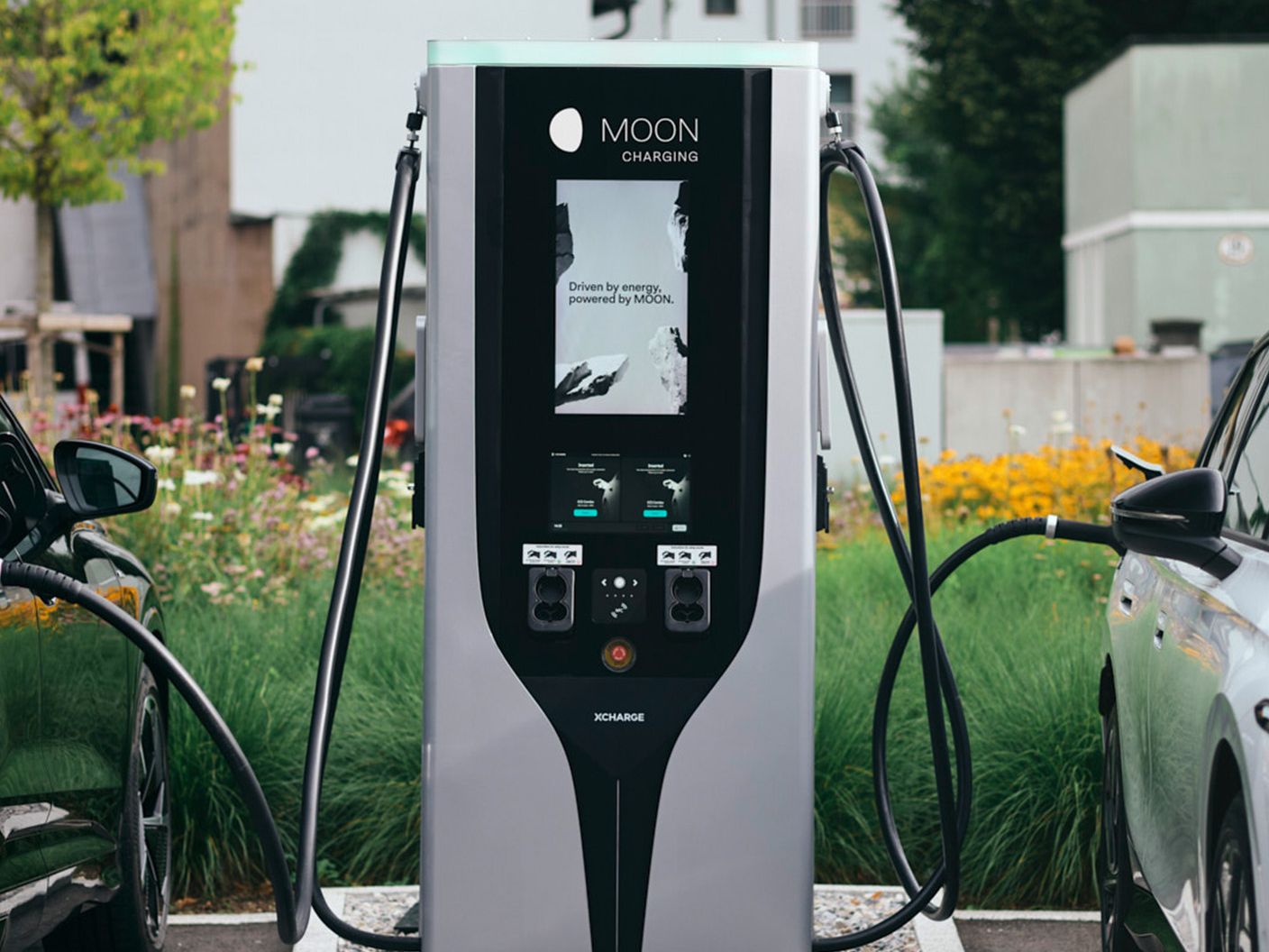 Fast charging station plugged into two electric cars