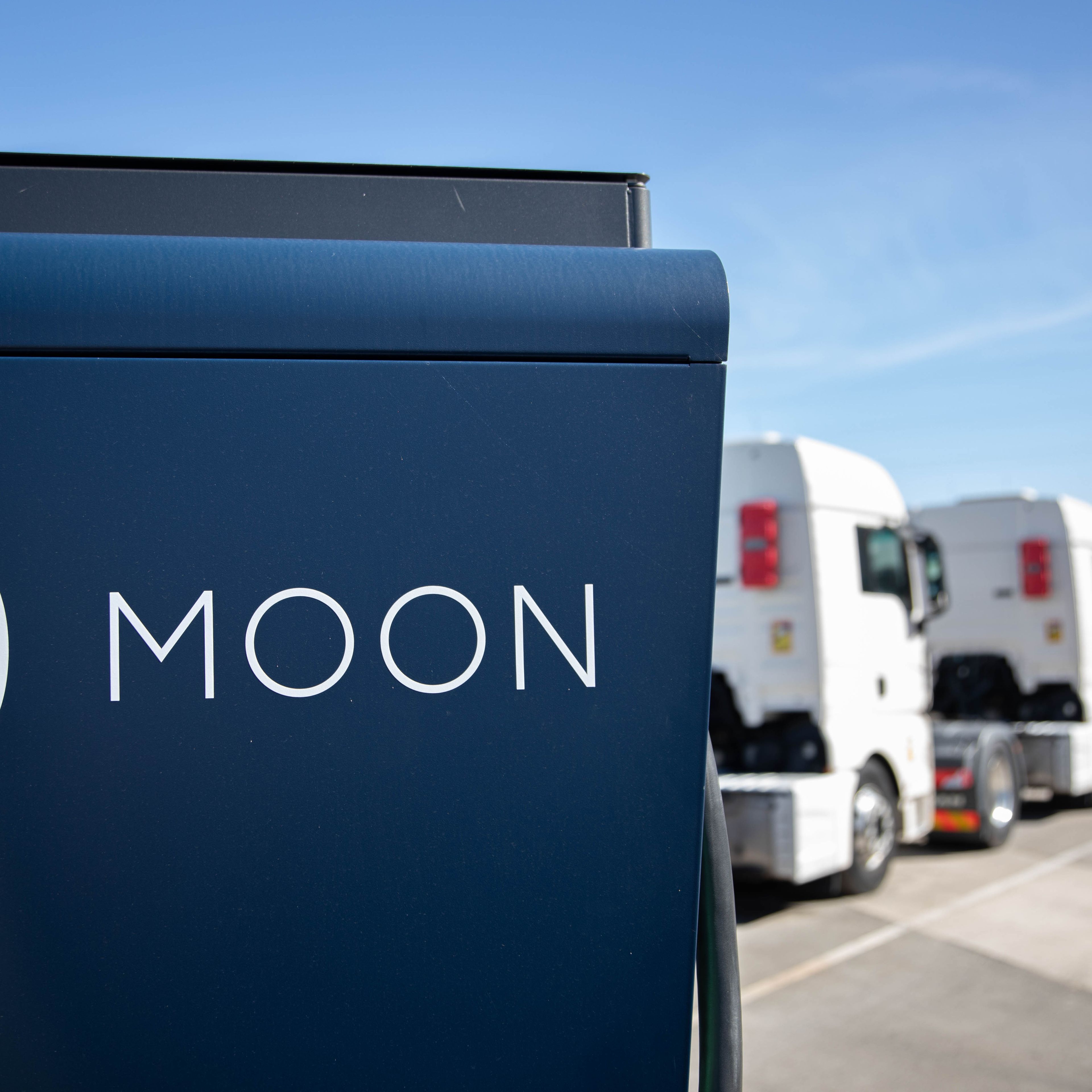 two trucks are parked behind a HYC 200-400 fast charging station