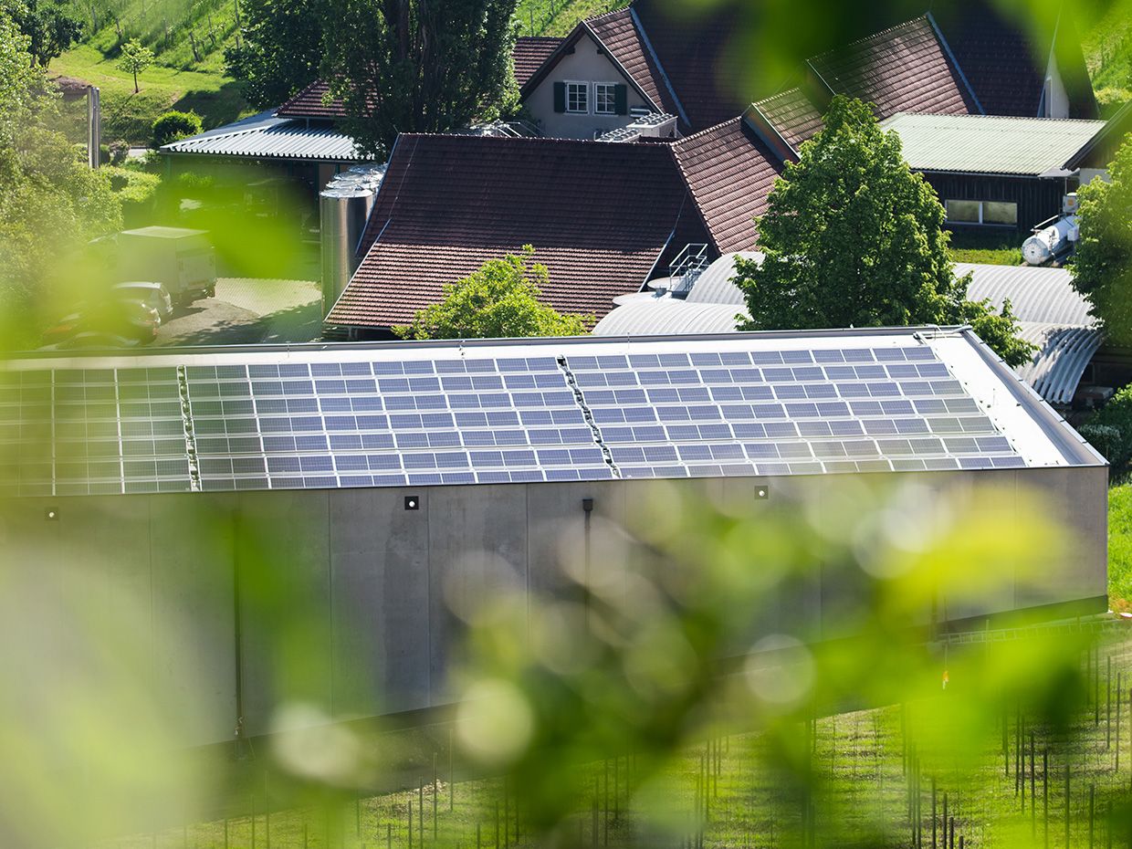 Photovoltaic system on the roof in front of a group of houses