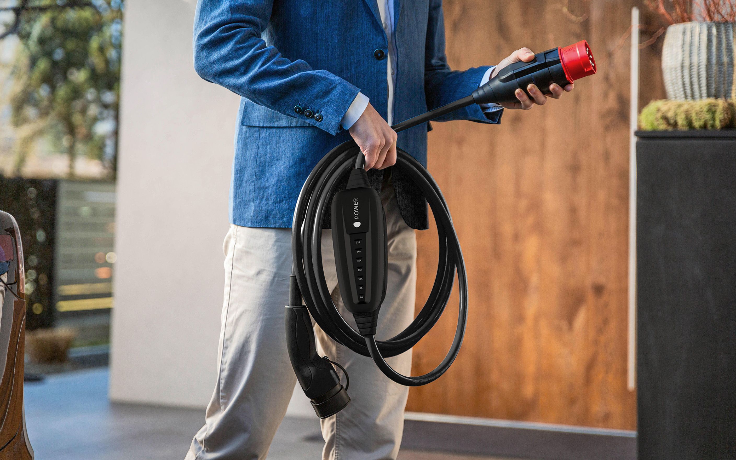A man holds the plug of a cable in his hand