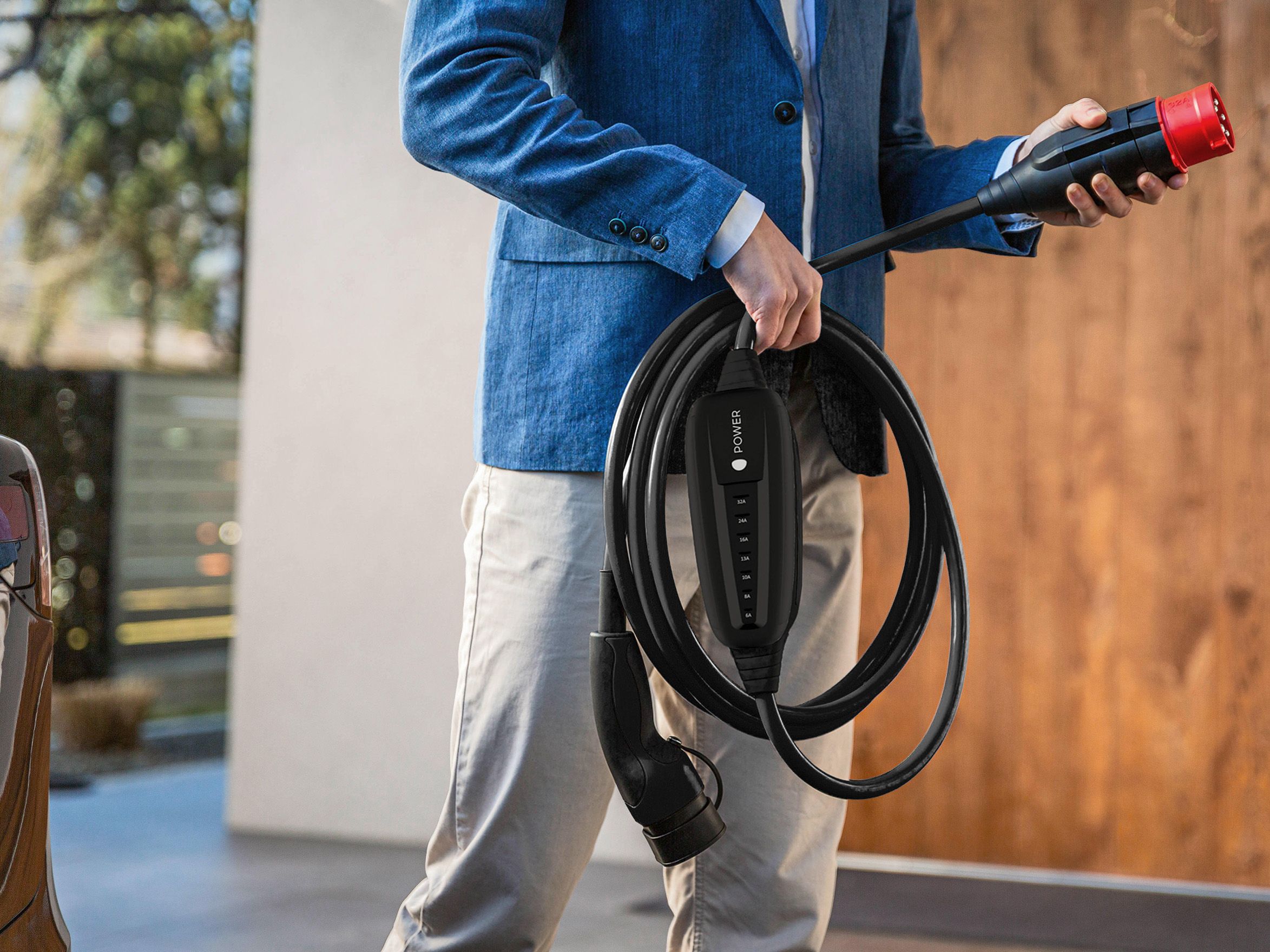 A man holds the plug of a cable in his hand