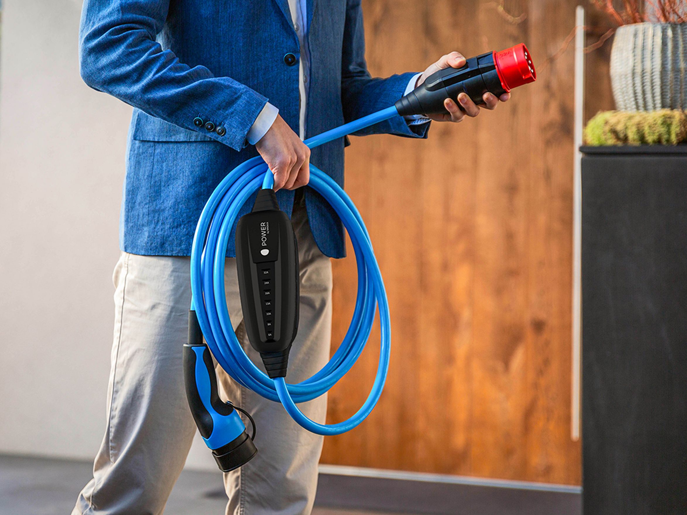 A man holds the plug of a cable in his hand