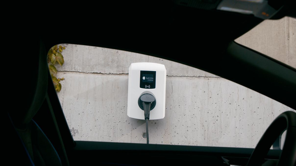 Wallbox on a wall photographed from a car