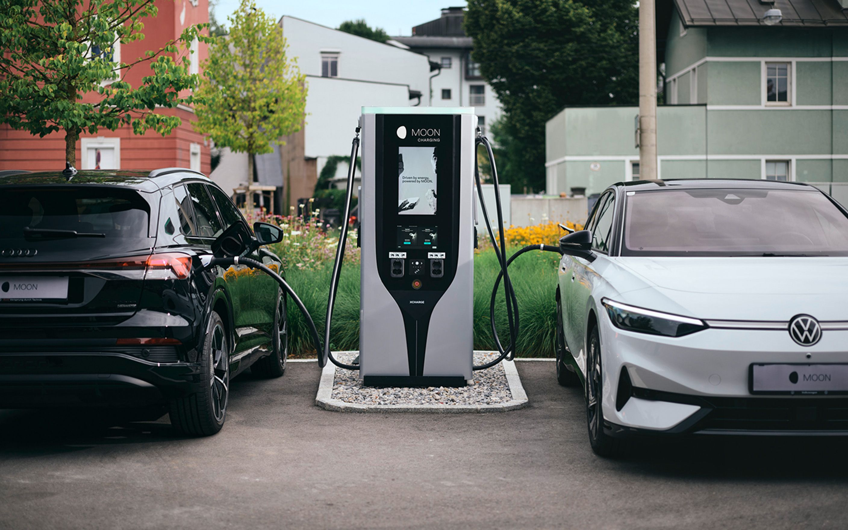 Plugged-in charging station between two cars