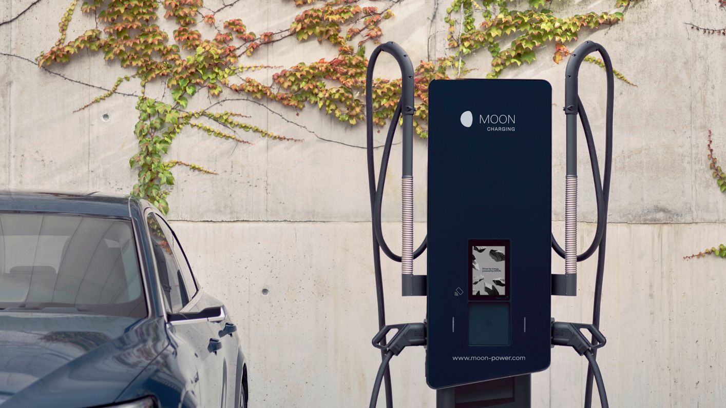 Auto steht neben einer Ladestation