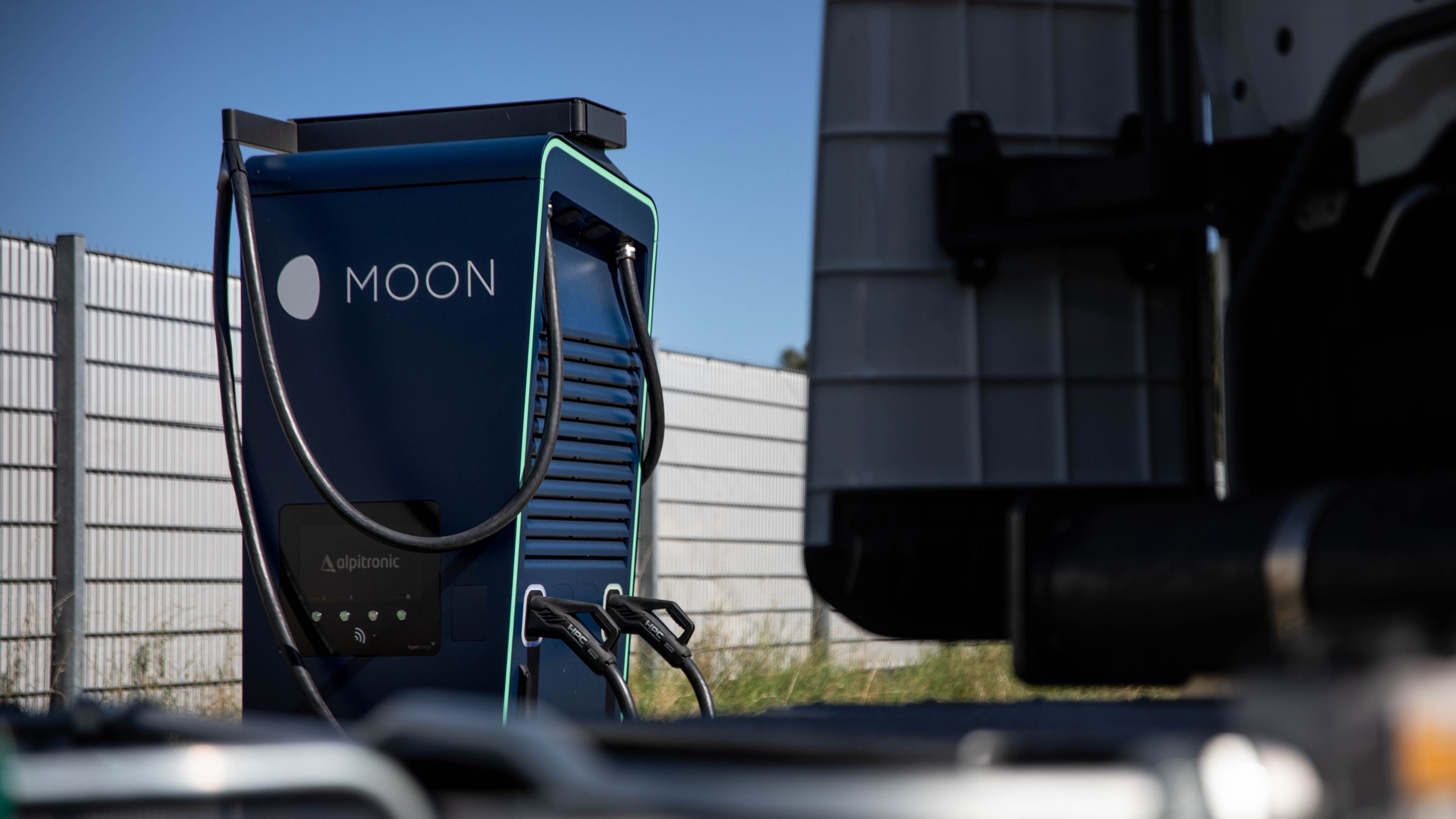 a truck stands in front of a HYC 200-400 fast charging station