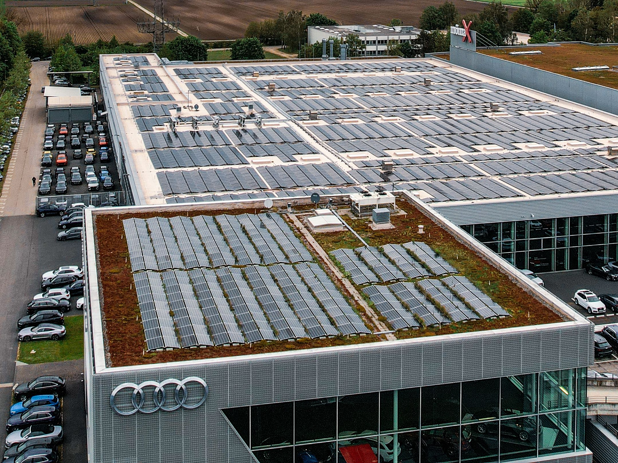 PV system on a roof next to a parking lot
