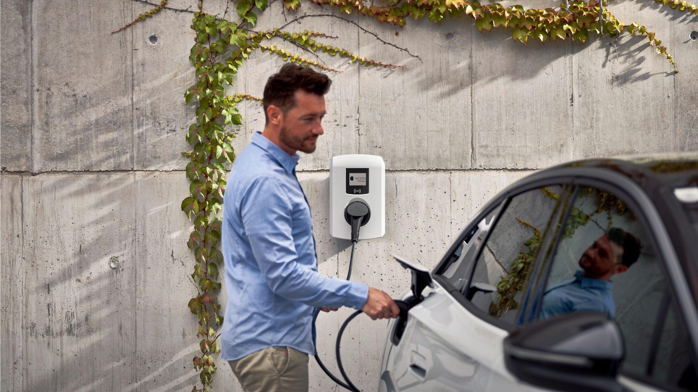 Man charging car with a wallbox