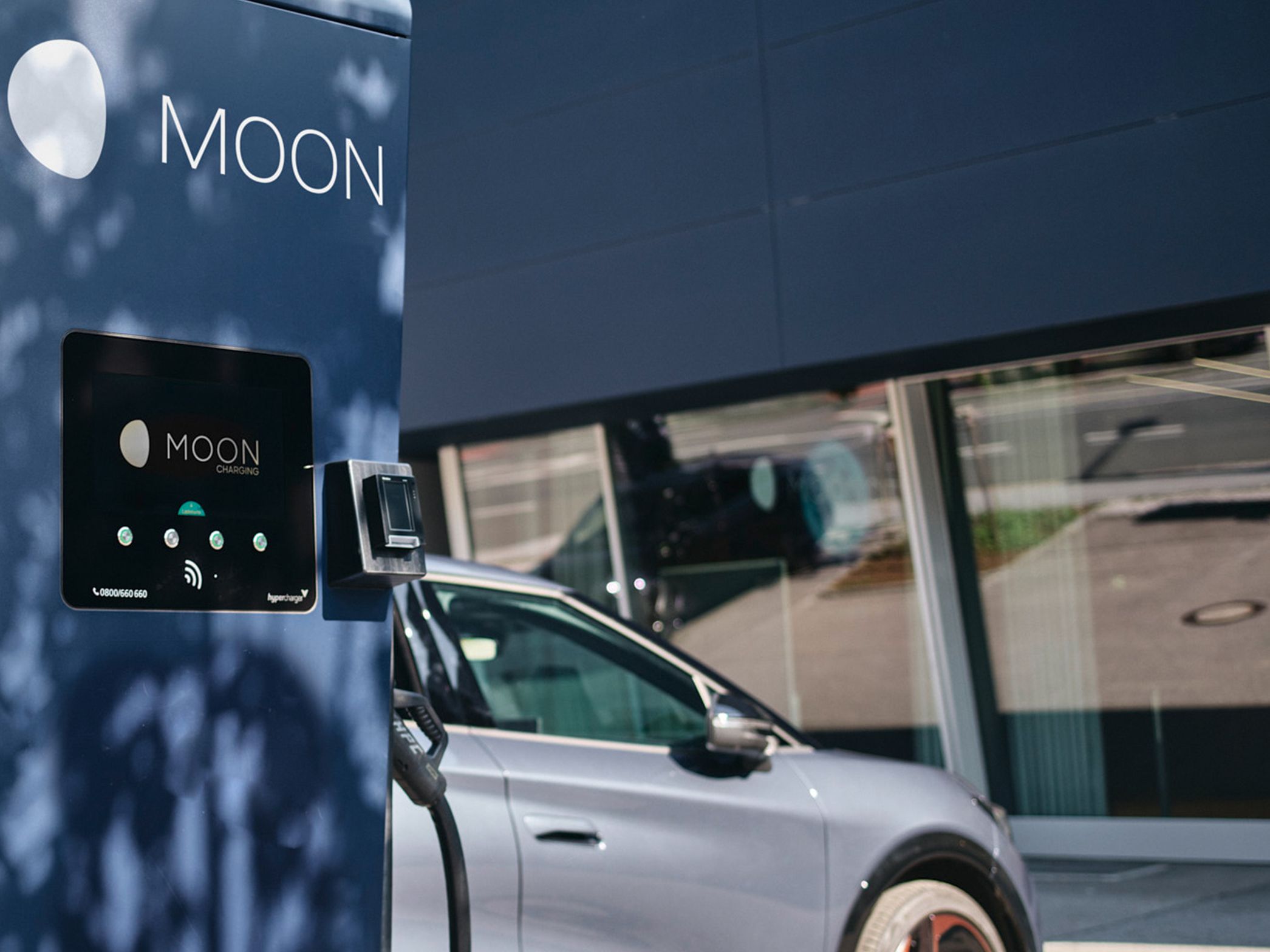 Fast charging station in front of an electric car with a display