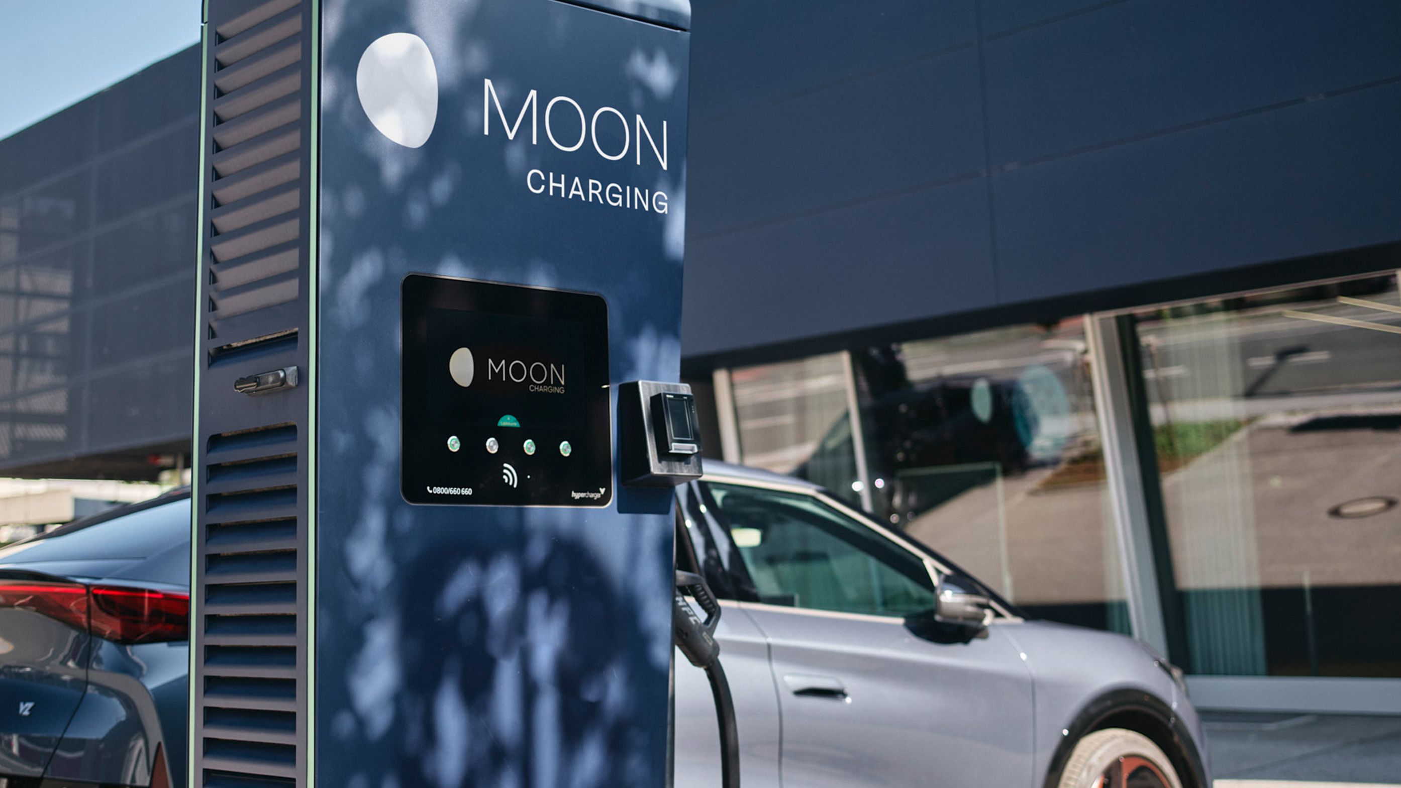 Charging station in front of a car with a display
