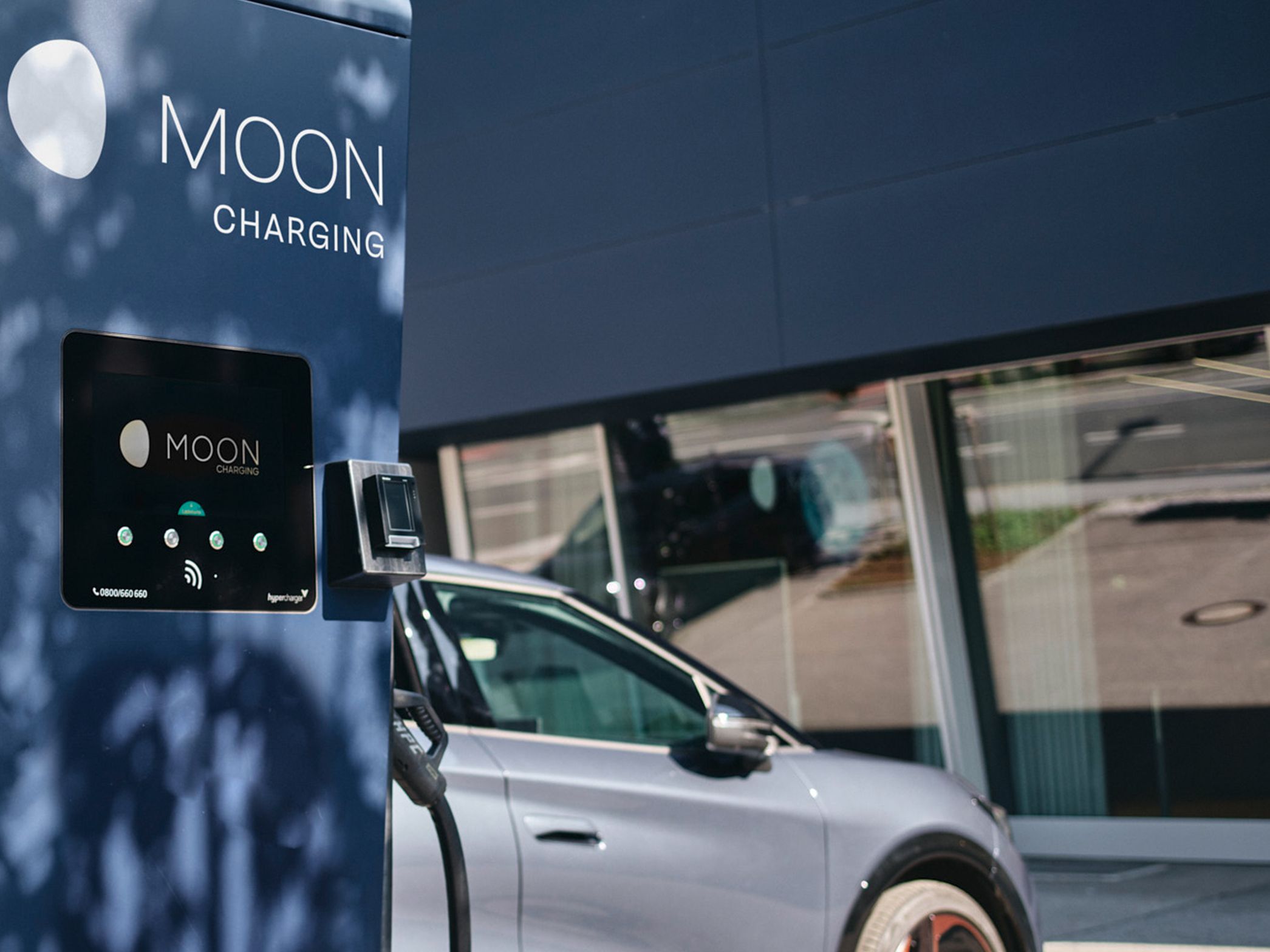 Charging station in front of a car with a display